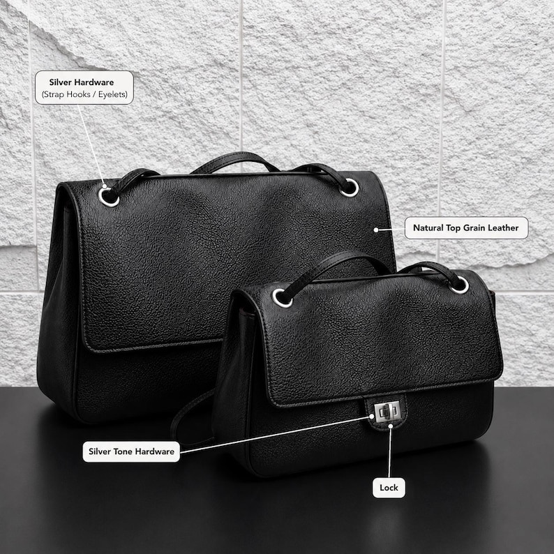 Two black top grain leather handbags shown with labeled features including natural top grain leather, silver hardware eyelets, silver tone lock closure, and structured flap design. The bags are displayed on a dark surface with a textured stone background, highlighting premium craftsmanship and everyday elegance.