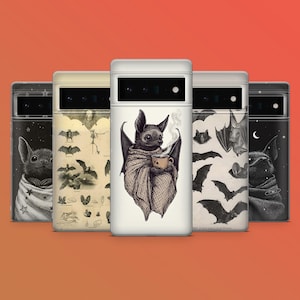May include: A collection of phone cases with bat-themed designs. One case features a bat wrapped in a blanket, holding a cup of coffee. Other cases display bat illustrations, a starry night, and vintage bat diagrams. The cases are set against an orange background.