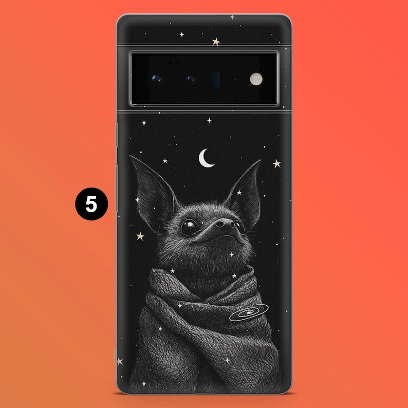 May include: Black phone case featuring a detailed illustration of a bat-like creature wrapped in a scarf, set against a starry night sky with a crescent moon. The design includes a galaxy graphic and small star accents.