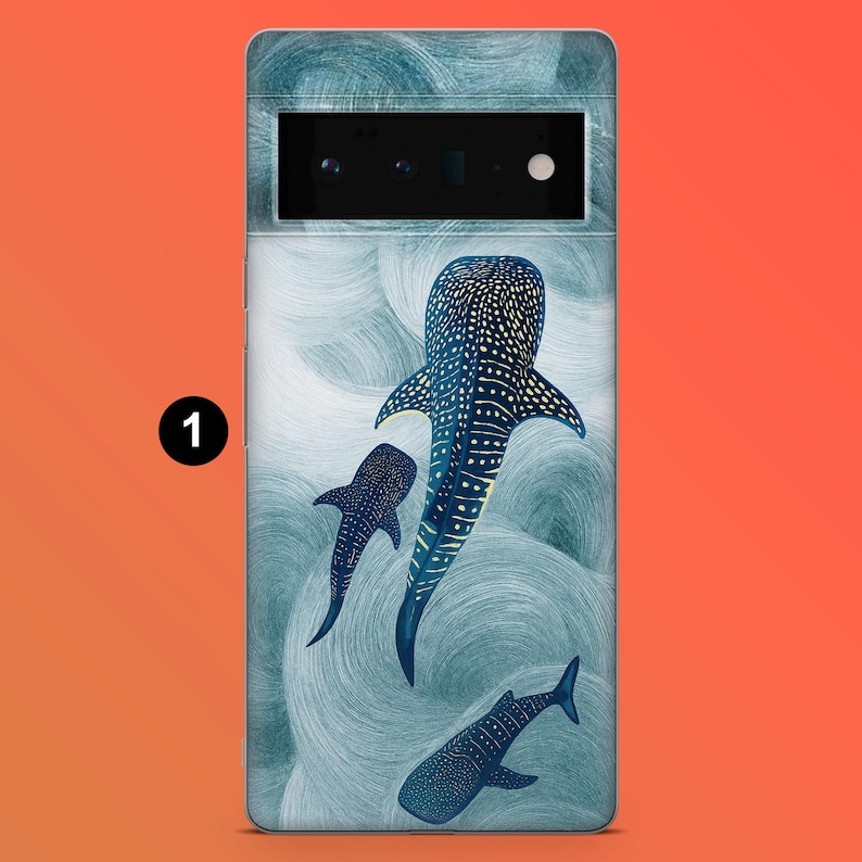 May include: A phone case featuring a design of three whale sharks swimming in a sea of swirling blue and white patterns. The whale sharks are dark blue with white spots and markings. The case is for a Google Pixel 6 Pro.