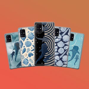 May include: A collection of phone cases with various ocean-themed designs. The cases feature illustrations of whale sharks, seashells, and wave patterns in shades of blue and white against a red-orange background.