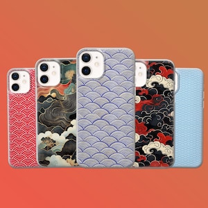 May include: A collection of phone cases with various Japanese-inspired designs. The cases feature patterns of red waves, a landscape scene, blue and white wave patterns, black clouds with red accents, and a light blue wave pattern. The cases are displayed against an orange background.