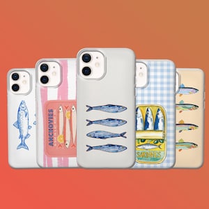 May include: A collection of phone cases with fish-themed designs. The cases feature illustrations of sardines, anchovies, and other fish, along with text. The cases have a variety of backgrounds, including white, pink stripes, and blue gingham.