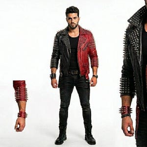 May include: A two-tone leather jacket, half black and half red, adorned with silver spikes. The jacket features a classic biker style with a notched collar, zipper details, and a belt. Matching spiked wristbands complete the edgy look.