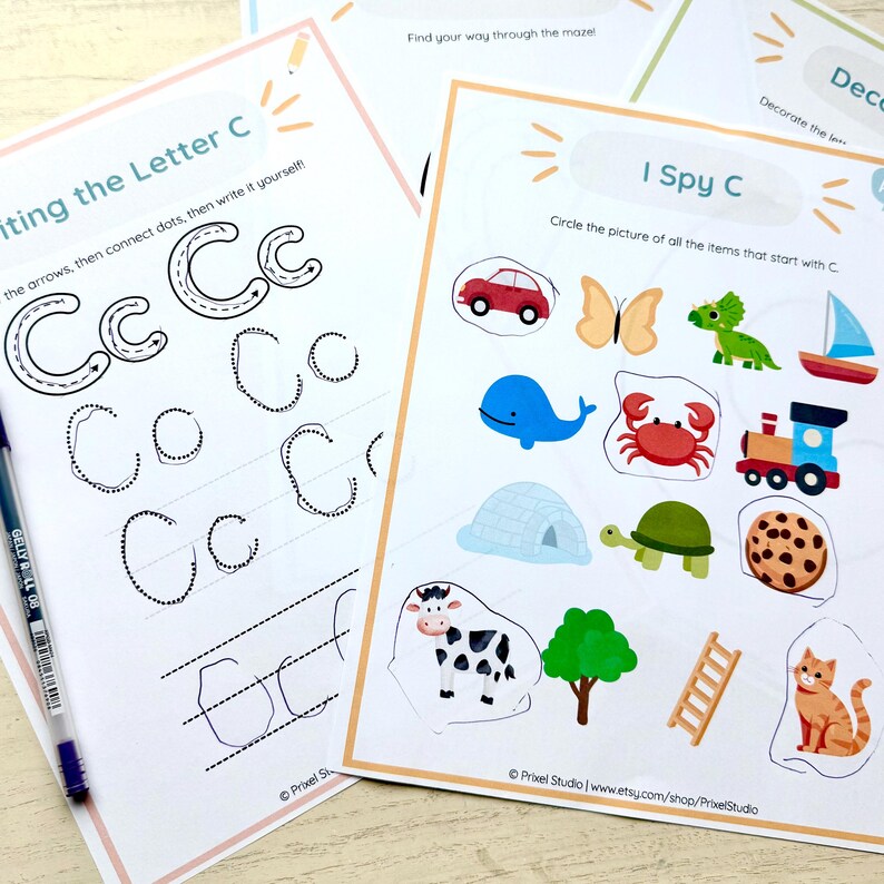 Puede incluir: Hojas de trabajo educativas para ni&ntilde;os. Una hoja presenta el texto "Writing the Letter C" con ejercicios de trazo. Otra, "I Spy C", muestra ilustraciones coloridas de elementos que comienzan con C, como un coche, una mariposa y un cangrejo.