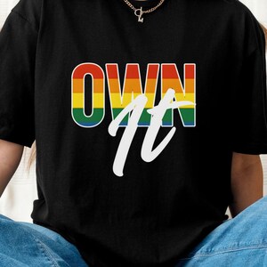 Pride Rainbow &quot;Own It&quot; T-Shirt, Core Neutral, LGBTQ Bold Typography Tee for Pride Month, Unisex Rainbow Graphic Shirt for Pride Parade, Gift