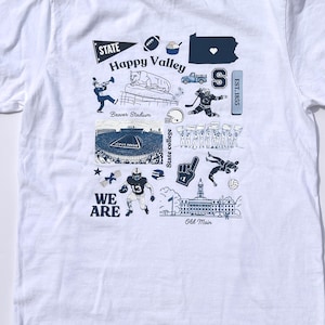 Peut inclure: T-shirt blanc avec un motif graphique bleu. Le motif comprend les mots "STATE Happy Valley" et des illustrations d'un ballon de football, d'un ours et d'un stade. Le texte "WE ARE" et "EST. 1855" sont également inclus.