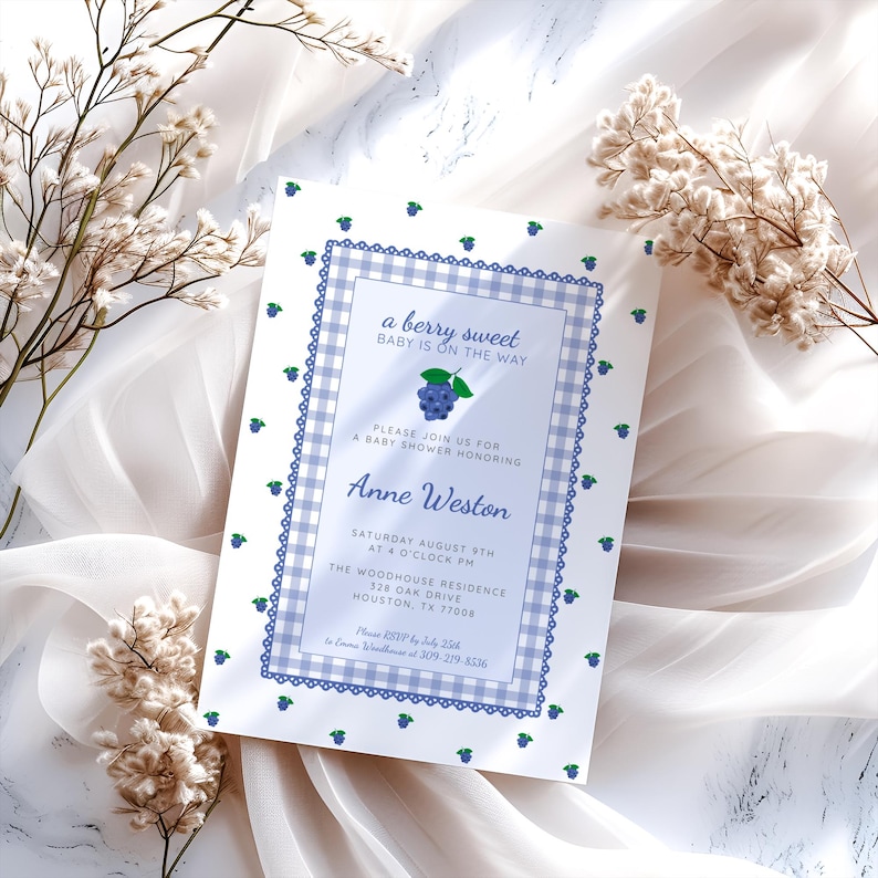 May include: A baby shower invitation with a blueberry theme. The invitation has a blue and white gingham border and the text "a berry sweet BABY IS ON THE WAY". The invitation includes the name Anne Weston and event details.
