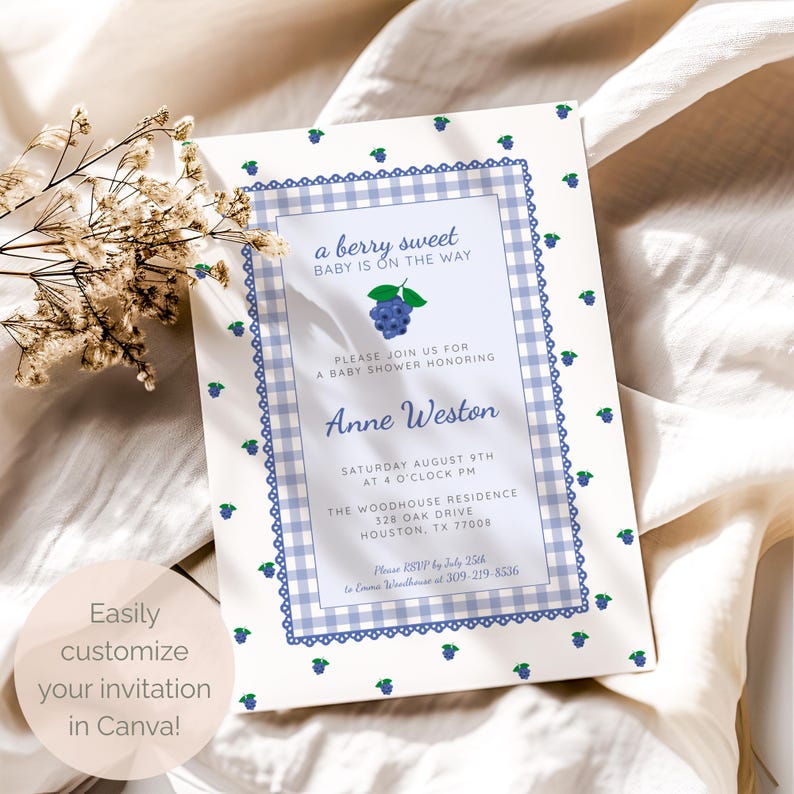 May include: A baby shower invitation with a blue gingham border and blueberry accents. The text reads "a berry sweet BABY IS ON THE WAY" and includes event details for Anne Weston's shower. The invitation is easily customizable in Canva.