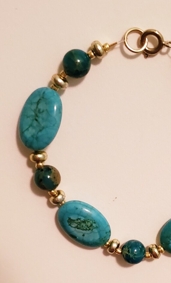 gold bracelet with turquoise stone