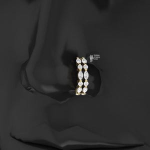 Peut inclure: Une paire de boucles d'oreilles en or avec une série de diamants taille marquise et ronds. Les boucles d'oreilles sont serties dans une monture en or et sont présentées sur un fond noir. Les boucles d'oreilles sont de la marque "Sherish Sparkle Gems."