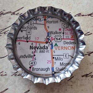 May include: A set of three ceramic mugs with a speckled, cream-colored glaze. Each mug features a different hand-painted floral design in shades of blue, green, and yellow. The mugs have a simple, rounded shape and a comfortable handle.