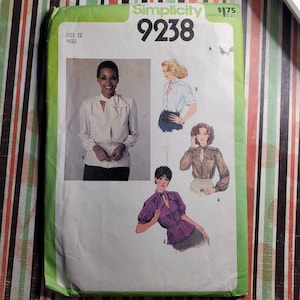 May include: Simplicity sewing pattern number 9238 for a blouse with a tie neck. The pattern includes four different styles of blouses, each with a different neckline and sleeve length. The pattern is for sizes 12 miss.