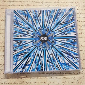 May include: A CD case with a blue and black abstract design. The text "SSI" is in the center of the design.