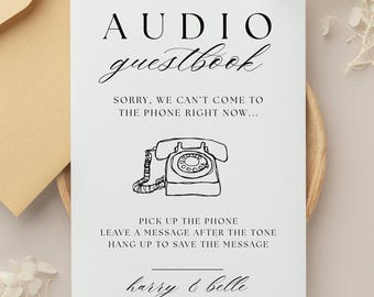 May include: A white card with black text that reads "AUDIO guestbook." Below the title is the phrase "SORRY, WE CAN'T COME TO THE PHONE RIGHT NOW..." A line drawing of a vintage telephone is in the center. The card also includes instructions and the names "harry & belle."