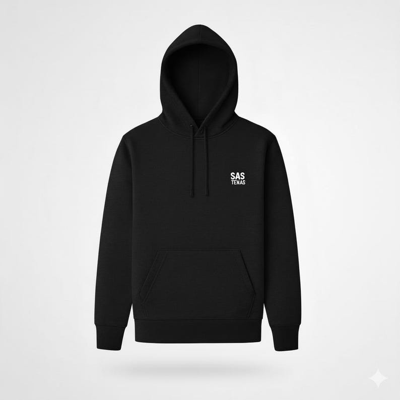 May include: Black hooded sweatshirt with a front pocket and drawstring. The white text "SAS TEXAS" is printed on the upper chest. The hoodie has a classic design and is suitable for casual wear.