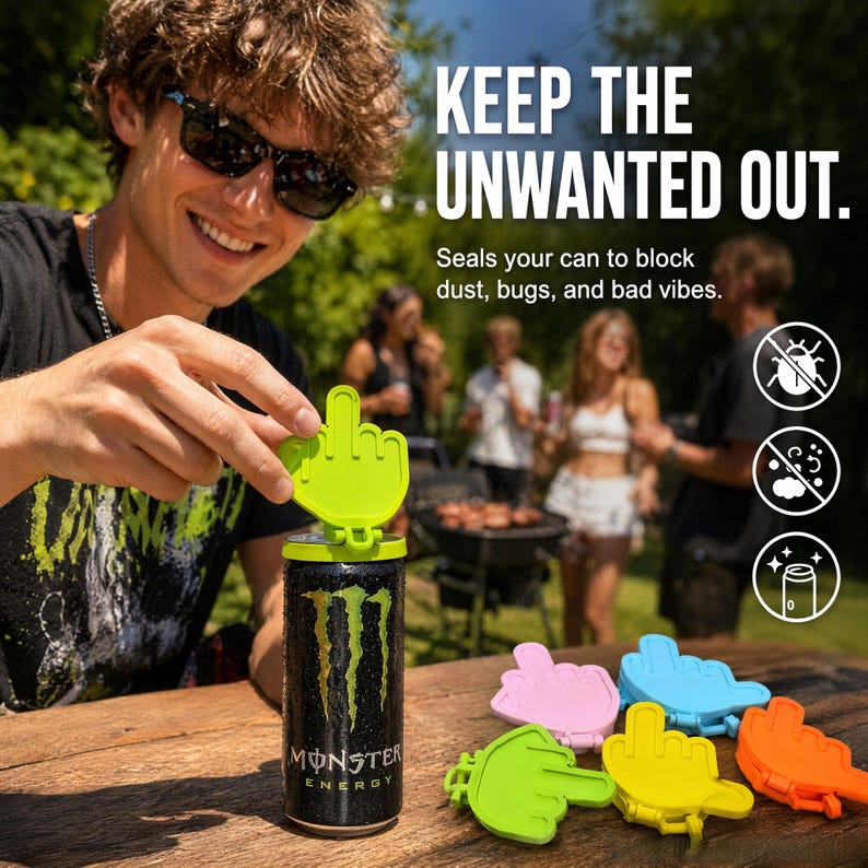 May include: A lime green plastic can cover shaped like a hand making a middle finger gesture, attached to a black Monster Energy drink can. Additional covers in pink, blue, yellow, and orange are arranged on the wooden surface nearby.