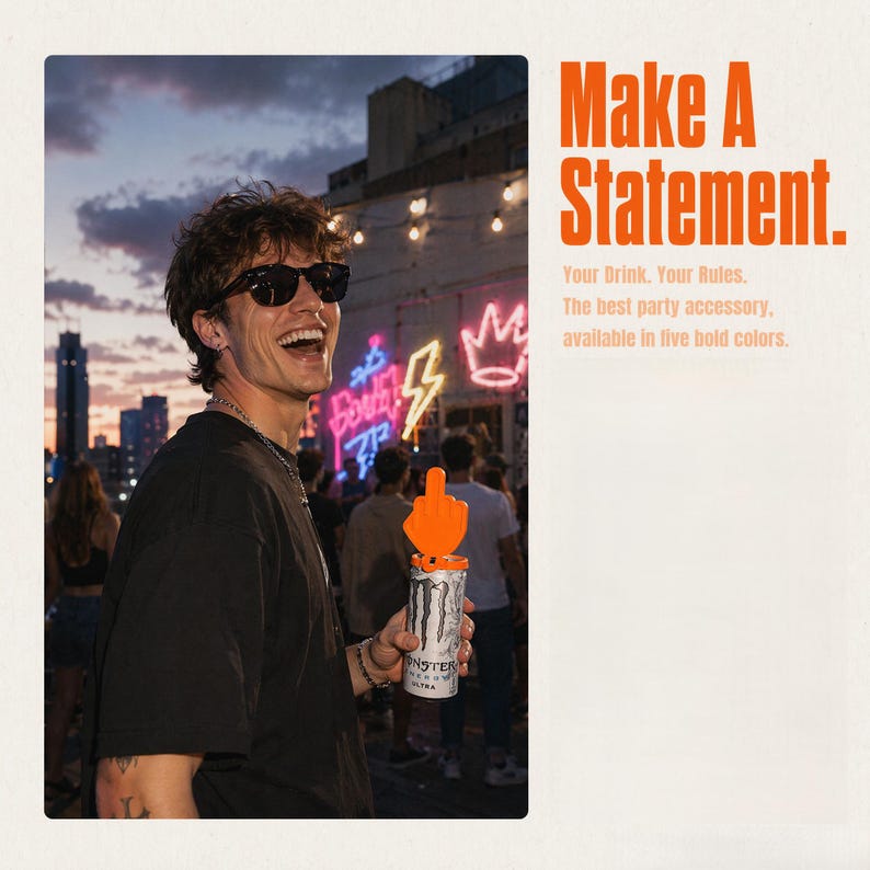 May include: An orange plastic middle finger topper attached to a white and black Monster Energy drink can. The text on the right reads: Make A Statement. Your Drink. Your Rules. The best party accessory, available in five bold colors.