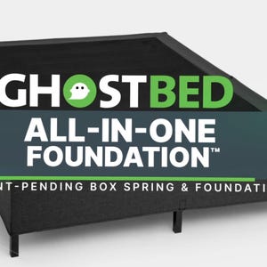 May include: A black GhostBed All-In-One Foundation. The product has a rectangular shape with four legs. The text "GHOSTBED ALL-IN-ONE FOUNDATION" is displayed in white and green. The text "PATENT-PENDING BOX SPRING & FOUNDATION" is also visible.