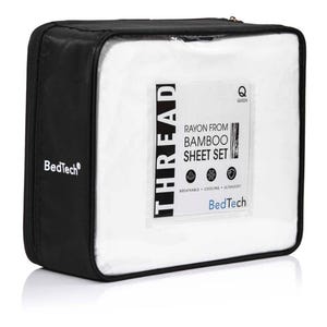 May include: A black zippered case containing a white sheet set. The clear front panel displays the text "THREAD RAYON FROM BAMBOO SHEET SET" with icons indicating breathability, cooling, and ultrasoft. The brand name "BedTech" is visible.