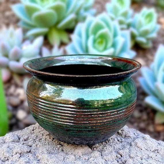虹色に輝くモスグリーンとブラウンの釉薬を施した陶器の鉢または植木鉢 