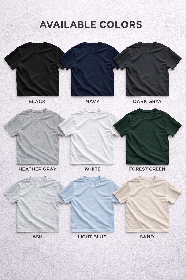 Puede incluir: Exhibici&oacute;n de nueve camisetas de manga corta en varios colores: negro, azul marino, gris oscuro, gris jaspeado, blanco, verde bosque, ceniza, azul claro y arena. El texto "AVAILABLE COLORS" est&aacute; en la parte superior.