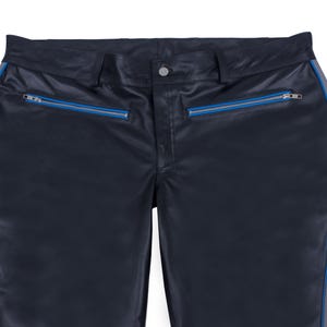A close-up of the waist and upper thighs of black leather pants, showing two horizontal pockets with blue zippers.