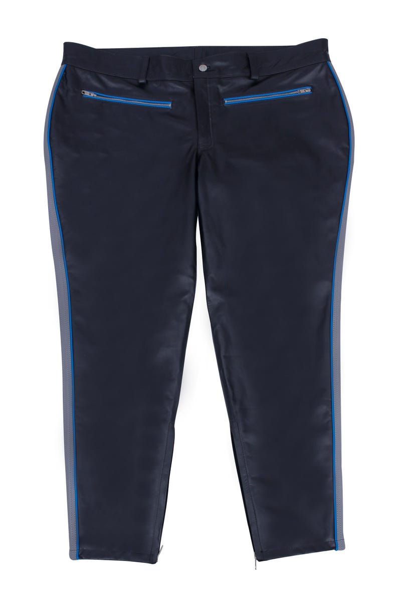 A pair of black leather pants with gray side stripes and blue piping, laid flat, front view.