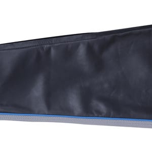 A close-up of the lower leg of black leather pants, showing a gray stripe with blue piping and a zipper at the ankle.