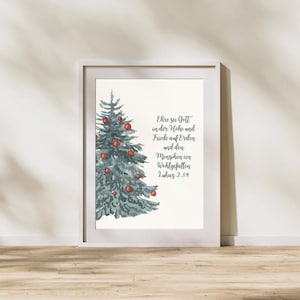 May include: A framed watercolor print featuring a Christmas tree adorned with red ornaments. The tree is painted in shades of blue-green. The print includes German text: "Ehre sei Gott in der Höhe und Friede auf Erden und den Menschen ein Wohlgefallen Lukas 2.14."