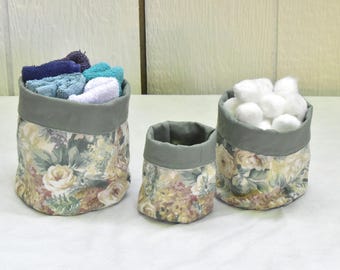 Set of 3  fabric canisters in a beige floral print. Home organizer baskets