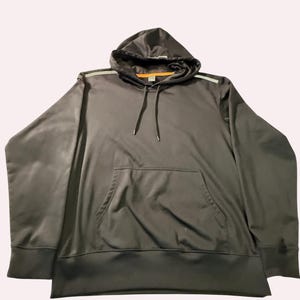 May include: A dark gray long-sleeve hoodie featuring a front kangaroo pocket, a hood with matching drawstrings, and thin reflective silver-toned stripes running along the top of the shoulders. The interior neckline is lined with orange trim.