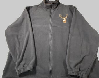 May include: A charcoal gray fleece jacket with a full zipper closure and a high collar. The jacket features an embroidered deer head on the upper left chest. The cuffs and collar have a brown trim.