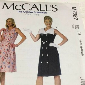 May include: McCall's M7087 sewing pattern envelope for a sleeveless dress from The Archive Collection, circa 1963. The cover displays two dress variations: a pink floral print dress with a belt and a solid black dress with a white collar and buttons.