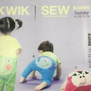 May include: A Kwik Sew sewing pattern envelope K4066 for toddler sizes T1-T4. The cover features illustrations of children wearing pants with animal face appliques on the back, including a green frog, a blue elephant, and a pink cow design.