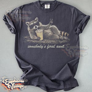 Funny Somebody's Feral Aunt Raccoon T-Shirt, Iced Coffee Raccoon Tee, Sarcastic Auntie Gift, Retro Trash Panda Graphic Graphite