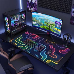 May include: A gaming setup featuring a curved monitor displaying a video game, a keyboard, mouse, and a large mousepad with a colorful, abstract design. A computer tower with LED lights and a headset are also visible.