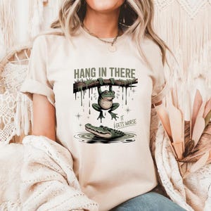 Hang in There It Gets Worse T-Shirt - Dark Humor Graphic Tee - Sarcastic Motivational Shirt - Unisex Tee for Adults - Ironic Quote Shirt