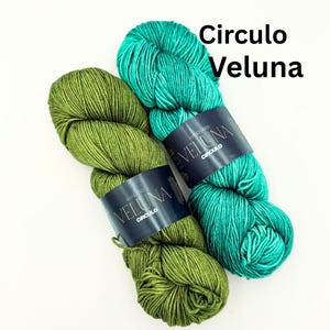 May include: Two skeins of yarn in shades of green and teal. The yarn is labeled "Veluna" by Circulo. The skeins are on a white background. The text "Circulo Veluna" is in the upper right corner.