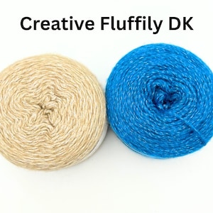 May include: Two balls of yarn, one beige and one blue, are shown against a white backdrop. The beige yarn is a light, neutral colour, while the blue yarn is a vibrant, bright shade. The text "Creative Fluffily DK" is at the top.