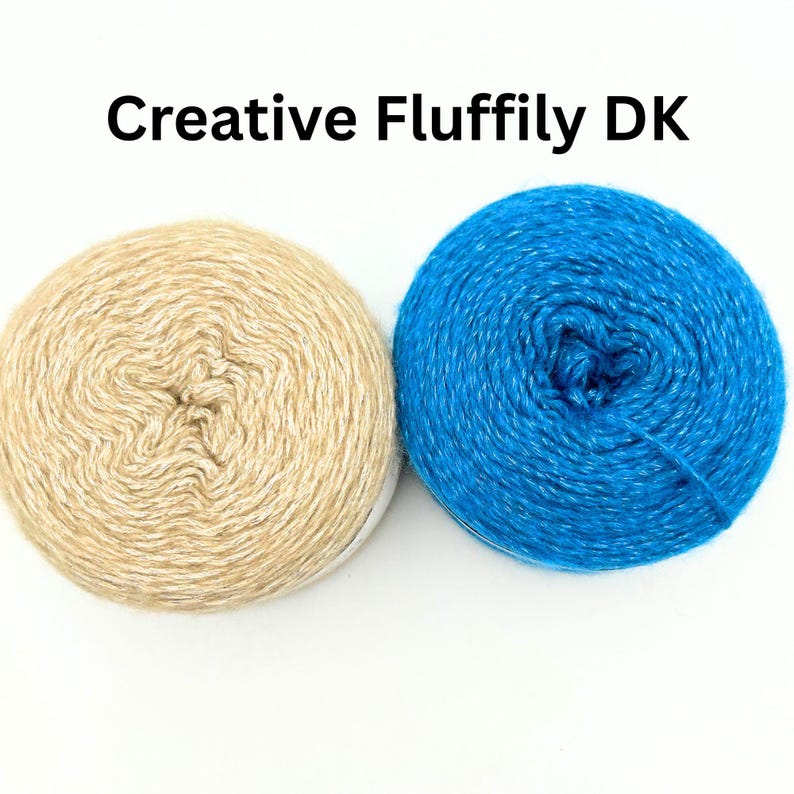 May include: Two balls of yarn, one beige and one blue, are shown against a white backdrop. The beige yarn is a light, neutral colour, while the blue yarn is a vibrant, bright shade. The text "Creative Fluffily DK" is at the top.