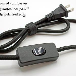 May include: A black cloth-covered electrical cord featuring a polarized plug and an inline on/off switch. The text states: The cloth covered cord has an inline on/off switch located 30" away from the polarized plug.