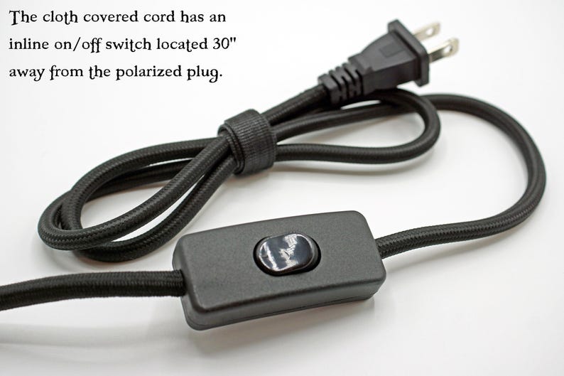 May include: A black cloth-covered electrical cord featuring a polarized plug and an inline on/off switch. The text states: The cloth covered cord has an inline on/off switch located 30" away from the polarized plug.