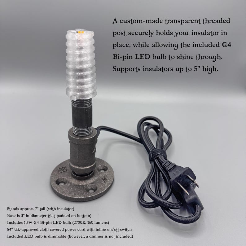 May include: A black metal pipe lamp base with a circular flange, a threaded post, and a transparent threaded top. It includes a 1.5W G4 bi-pin LED bulb, a 54-inch cloth-covered power cord with an inline switch, and supports insulators up to 5 inches high.