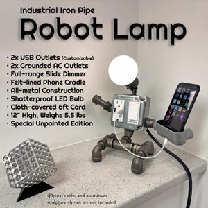 May include: Industrial iron pipe robot lamp with a light bulb head, outlets, and a phone cradle. The lamp is 12 inches high and weighs 5.5 lbs. Features include a slide dimmer and cloth-covered cord. The text on the image says "Robot Lamp".