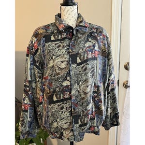 May include: A patterned jacket with a button-up front and a collared neckline. The jacket features a mix of colors, including brown, blue, red, and black, with a repeating heart design. The jacket is displayed on a mannequin.