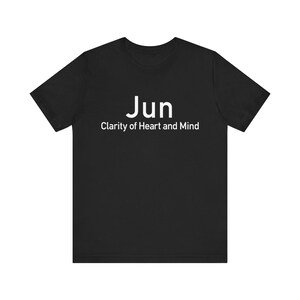 May include: Black t-shirt with the word "Jun" in white, above the phrase "Clarity of Heart and Mind." The shirt is a solid color and appears to be made of a soft material.