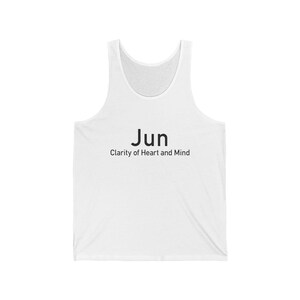 May include: White tank top with the word "Jun" printed in black, along with the phrase "Clarity of Heart and Mind" below it. The sleeveless shirt is made of a soft material.