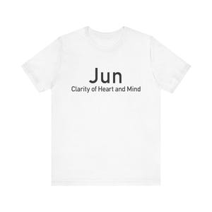 May include: White t-shirt with the word "Jun" in black, followed by "Clarity of Heart and Mind" in a smaller font. The shirt is made of a soft material and has short sleeves.