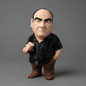 A Tony Soprano display statue wearing a black short-sleeve button-down shirt, brown pants, and a gold watch, holding a cigar.